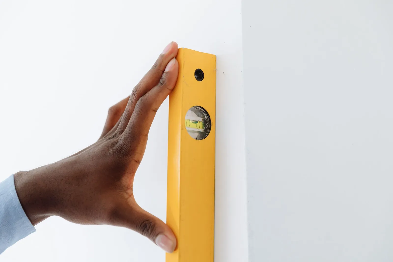 Spirit level placed diagonally across pool table slate in four-direction check