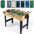 Wooden multi-game table with green felt pool surface in a bright rec room